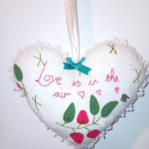 Love is in the air - a hanging heart with a whimsical 'love note'